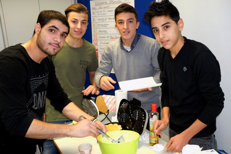 Mit Feuereifer dabei: Schüler der Internationalen Förderklassen backen und verkaufen leckere Waffeln für den guten Zweck. (Foto: Schule)